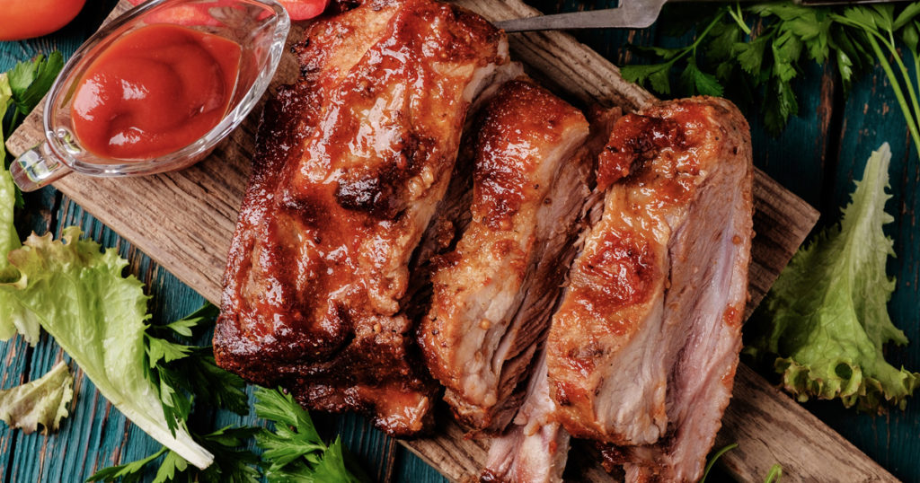 Barbecue ribs with sauce on cutting board