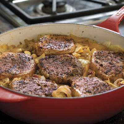 Skillet cooking pork chops with cabbage and apples